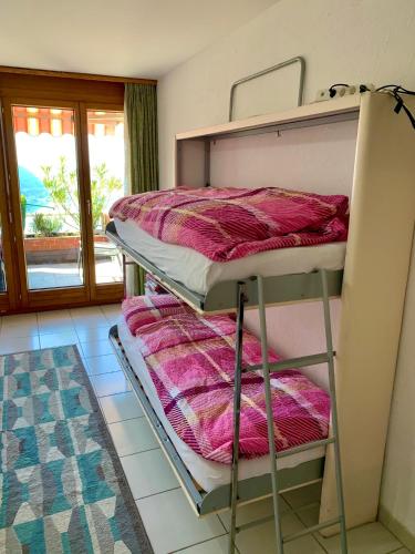 a bunk bed in a room with a window at Casa Belvedere in Rovio