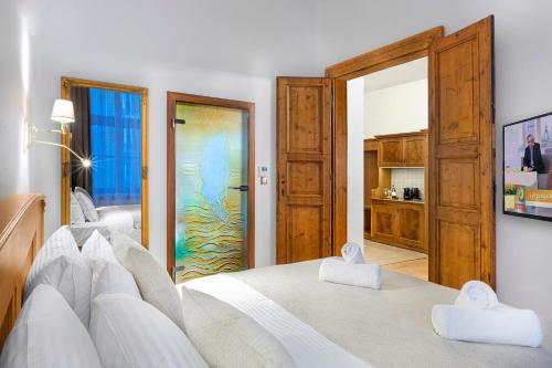 a bedroom with a bed with two white towels at Ventus Rosa Boutique Aparthotel in Kraków