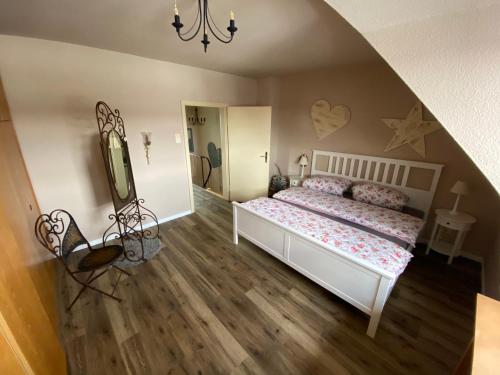 een slaapkamer met een wit bed en een spiegel bij Ferienhaus am Scharnhorst in Hameln