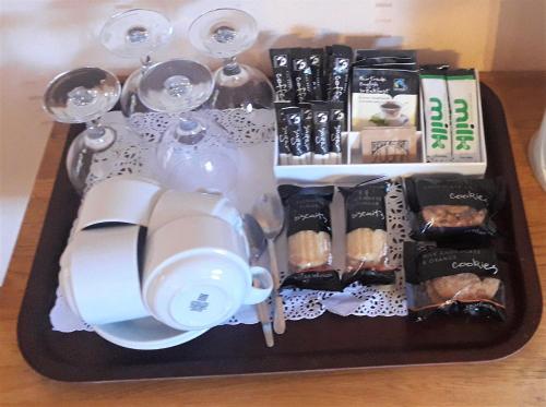 a tray with wine glasses and a tray of food at Lyndon Guest House in Inverness