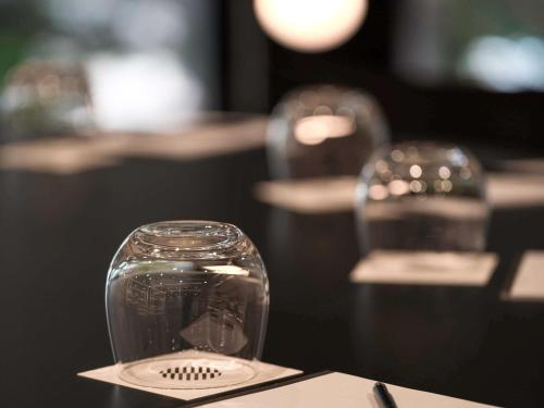 a glass vase sitting on top of a table at Pullman Sydney Airport in Sydney