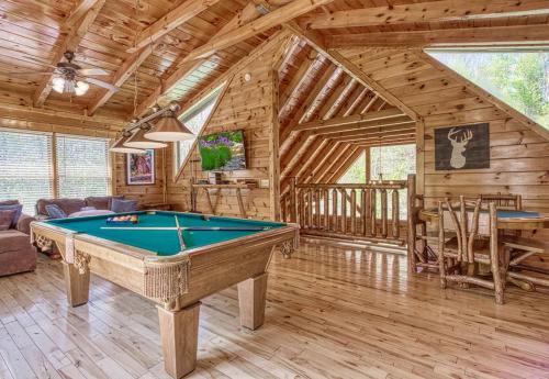 a room with a pool table in a cabin at Heavenly Bear, Hot Tub, FREE Attraction tickets for each paid day, Pool Table, WIFI!!! in Sevierville