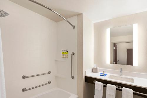 a bathroom with a sink and a toilet and a tub at Holiday Inn Express Hotel & Suites Durant, an IHG Hotel in Durant