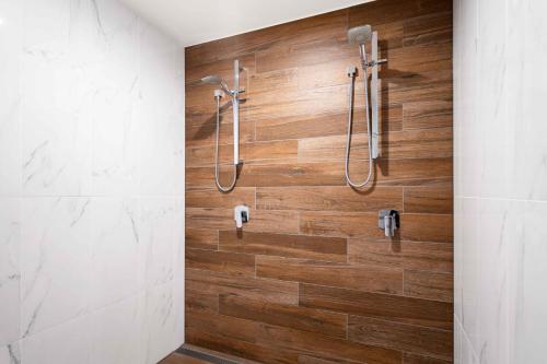 a bathroom with a shower with wooden walls at Luxury Spa Retreat with Ocean and Hinterland Views in Montville