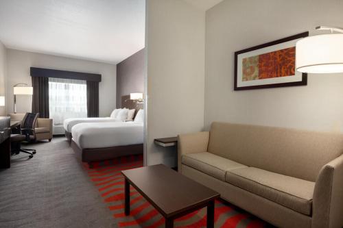 a hotel room with a couch and a bed at Comfort Suites Boise West Meridian in Meridian