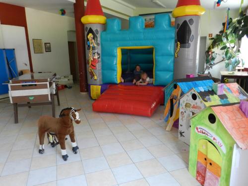 a room with a play room with a toy horse at Freinerhof & Wellness in Neuberg an der Mürz