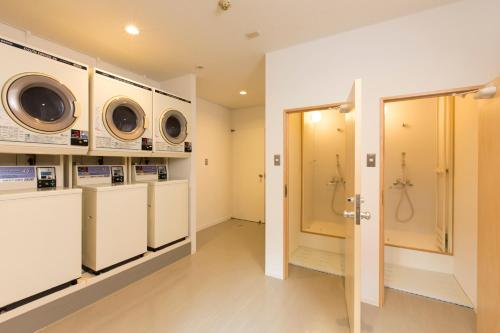 a laundry room with washing machines and a shower at Showa Forest Village in Chiba
