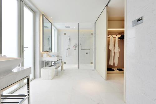 a bathroom with a walk in shower and a sink at Palace Resort Villas Yalong Bay Sanya in Sanya