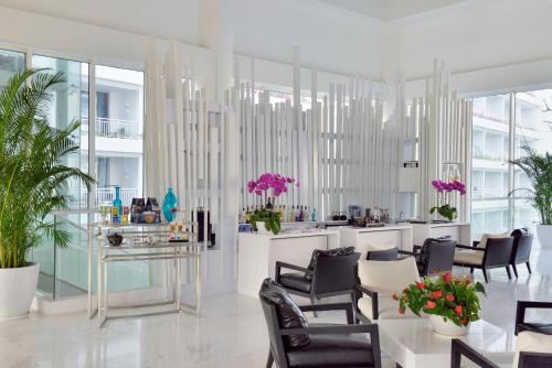 a salon with chairs and a counter with pink flowers at Palace Resort Villas Yalong Bay Sanya in Sanya