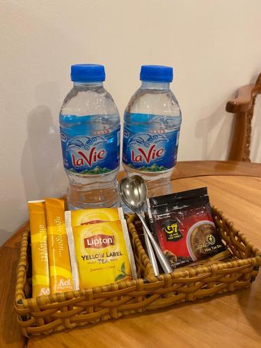 a basket of food and two bottles of water on a table at Hoang Son Hotel - Can Tho in Can Tho