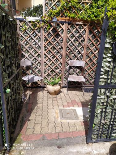 a wooden gate with two chairs and a plant at B&B SAN FRANCESCO Pescara Centro in Pescara