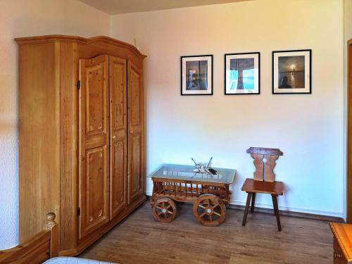 a room with a large wooden cabinet and a table at Landlust Hotel in Gransee