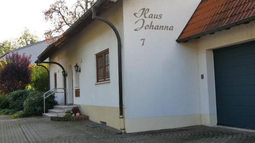 a white building with a blue garage door at Haus Johanna in Glottertal