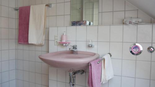 a bathroom with a pink sink and towels at Haus Johanna in Glottertal