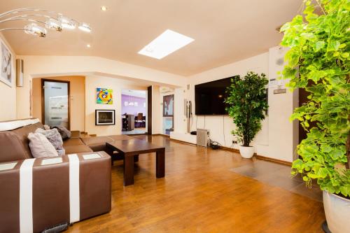 a living room with a couch and a table at Apartment Warsaw City Center in Warsaw