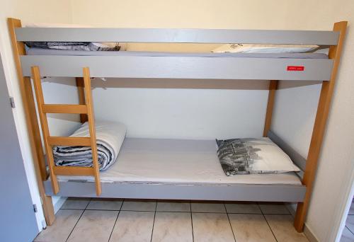 a bunk bed with a ladder in a room at Le Prorel appartement au pied du télécabine in Briançon