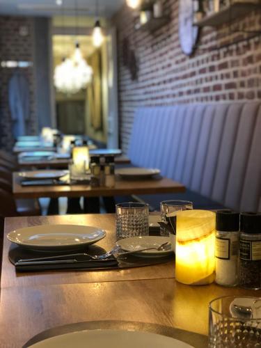 a table with plates of food on it in a restaurant at Boutique Hotel Caelus VII in Tongeren