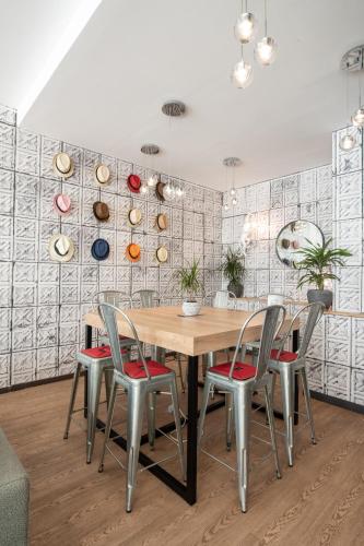 a dining room with a wooden table and four chairs at Novotel Avignon Centre in Avignon