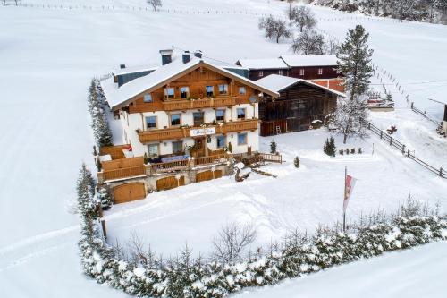 an aerial view of a house in the snow at Ferienwohnungen Behamhof in Neukirchen am Großvenediger