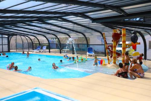 a group of people in a swimming pool at CAMPING PARADIS Domaine Oyat in Le Fenouiller