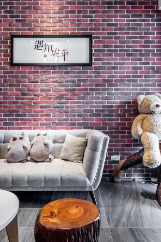 a living room with a couch and two teddy bears at Meets Anping in Tainan