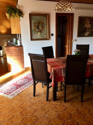 a dining room with a table and chairs at Helga Vendégház in Budaörs