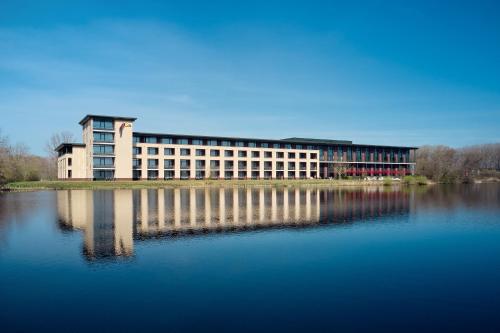 a large building next to a large body of water at Van der Valk Hotel Sneek in Sneek