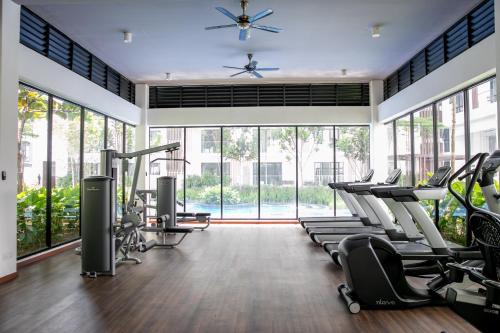 a gym with treadmills and cardio equipment and large windows at The Tropic@Midhill Genting (Free Wi-Fi) in Genting Highlands