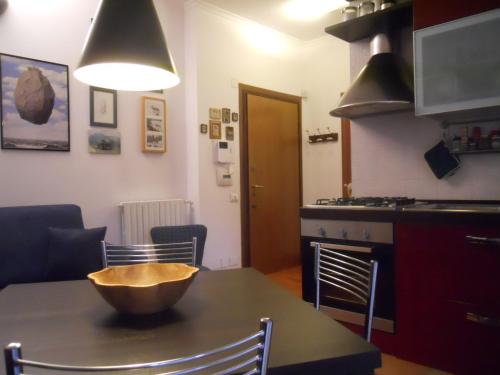 a kitchen with a table with a bowl on top of it at L'Appartamento di Villa Bonelli in Rome