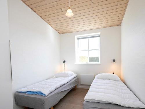 A bed or beds in a room at Apartment Faaborg III