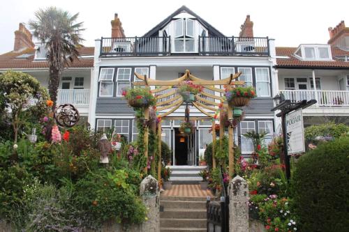 a large house with a welcoming arch in front of it at Poltair Guest House in Falmouth