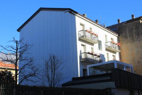a white building with balconies on the side of it at SoloSonno in Lecco