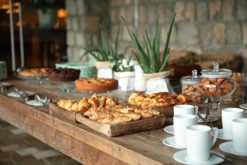 a table with many different types of pastries on it at Aquapetra Resort & Spa in Telese