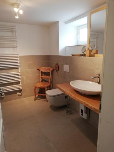 a bathroom with a sink and a toilet and a mirror at Seepferdchen in Timmendorfer Strand