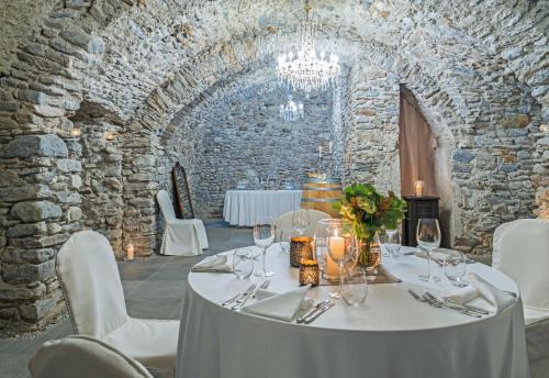 a dining room with a table with wine glasses at Boutique & Business Hotel La Tureta in Bellinzona