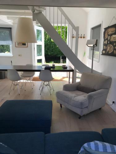 a living room with a couch and a table at IJSSELMEER Lake houses in Andijk