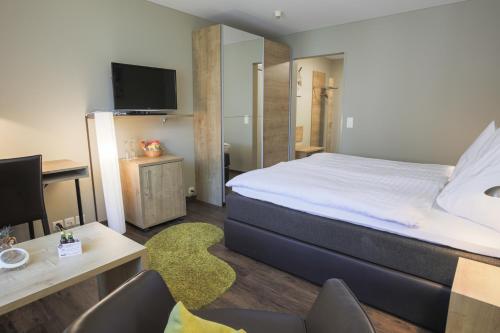 Ένα ή περισσότερα κρεβάτια σε δωμάτιο στο Herisau Swiss Quality Hotel