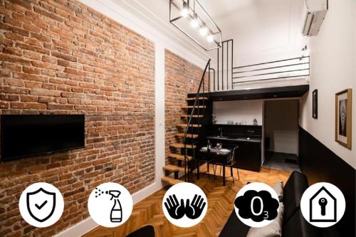 a living room with a brick wall and a tv at DIETLA 99 APARTMENTS - IDEAL LOCATION - in the heart of Krakow in Kraków