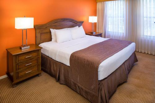 a hotel room with a large bed and two lamps at Villas de Santa Fe in Santa Fe