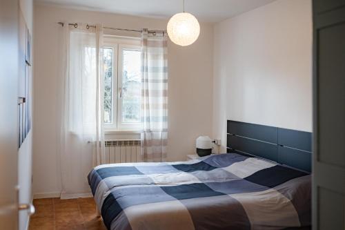 a bedroom with a bed and a large window at Le Radici in Isola del Piano