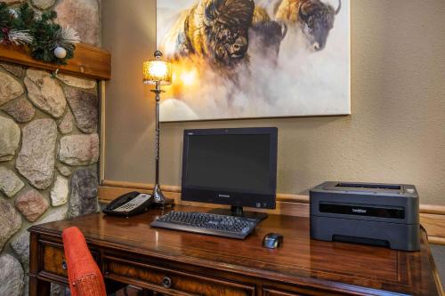 a desk with a computer and a printer on it at AmericInn by Wyndham Grand Forks in Grand Forks
