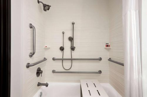 a bathroom with a tub and a shower stall at Days Inn by Wyndham Beaumont West I-10 Walden in Beaumont