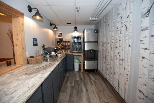 a kitchen with a counter and a refrigerator at Mountain Inn at Lutsen in Lutsen