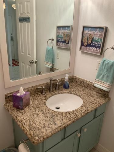 a bathroom counter with a sink and a mirror at Bahama Breeze #4 Sea Dancer Condos in South Padre Island