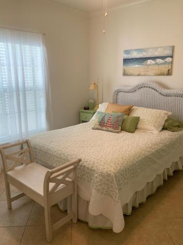 a bedroom with a bed with a chair and a window at Bahama Breeze #4 Sea Dancer Condos in South Padre Island