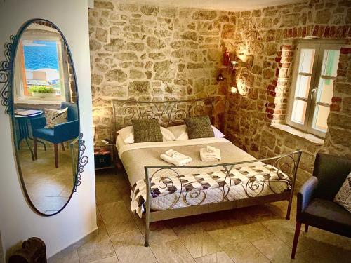a bedroom with a bed and a mirror at City Rooms Šibenik in Šibenik