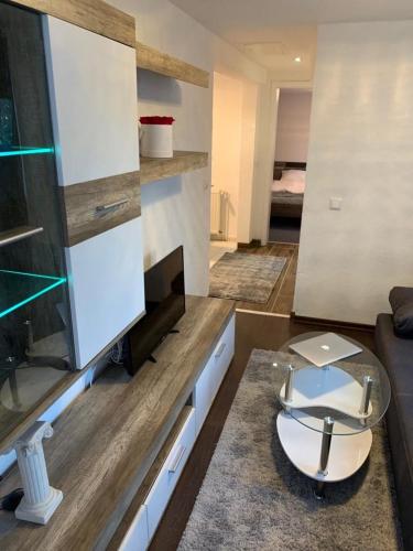 a living room with a couch and a tv at UsedomTor 1720 FeWo I in Wolgast