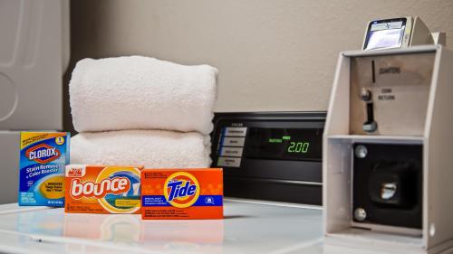 a stack of paper towels sitting next to a toaster oven at SureStay Hotel by Best Western Orange in Orange