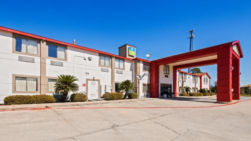 an empty parking lot in front of a building at SureStay Hotel by Best Western Orange in Orange