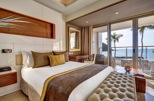 a bedroom with a bed and a view of the ocean at Royalton Saint Lucia, An Autograph Collection All-Inclusive Resort in Gros Islet